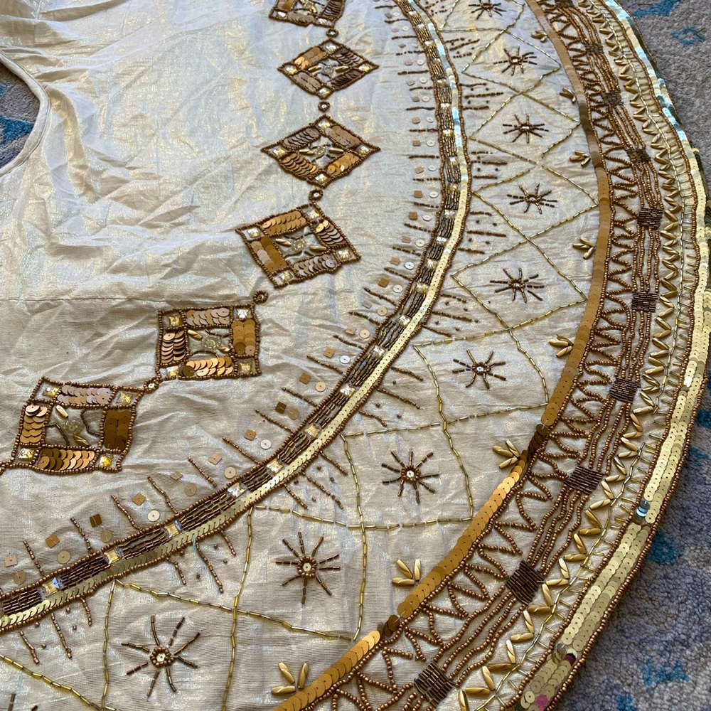 Gold beaded Christmas tree skirt by Kim Seybert
